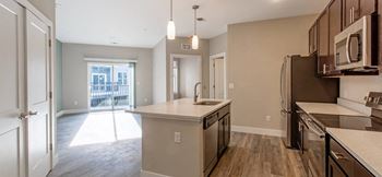 an empty kitchen with a sink and a refrigerator at The Flats at Summit Station, South Park, 15129